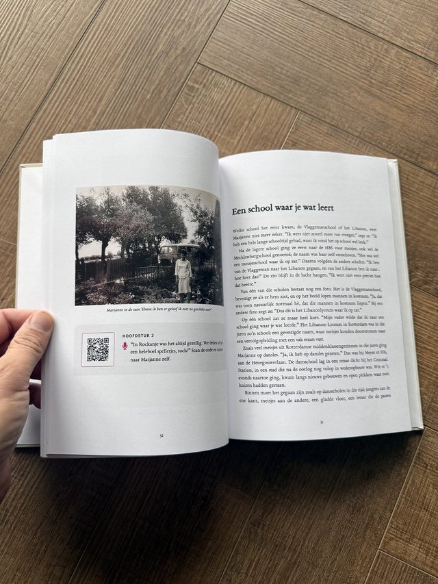 An open book with an old photo and a code to listen to part of the conversation